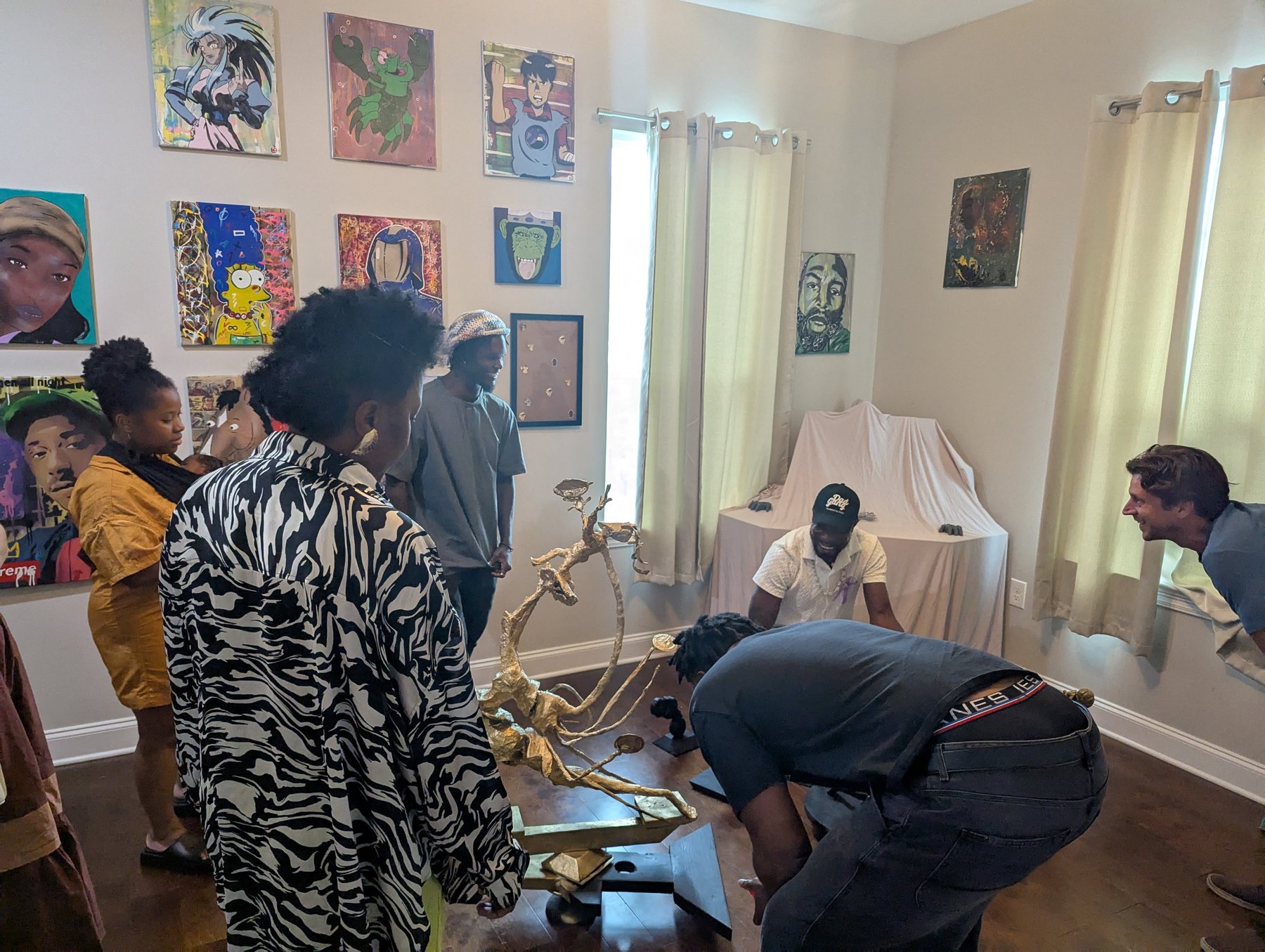 A wide view of artwork and sculpture inside Rosser Gallery
